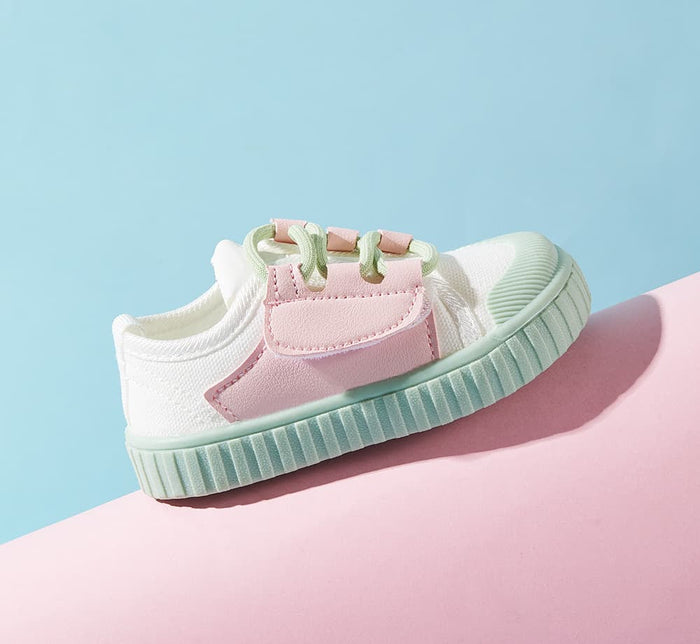 Baby sneaker on a pastel background